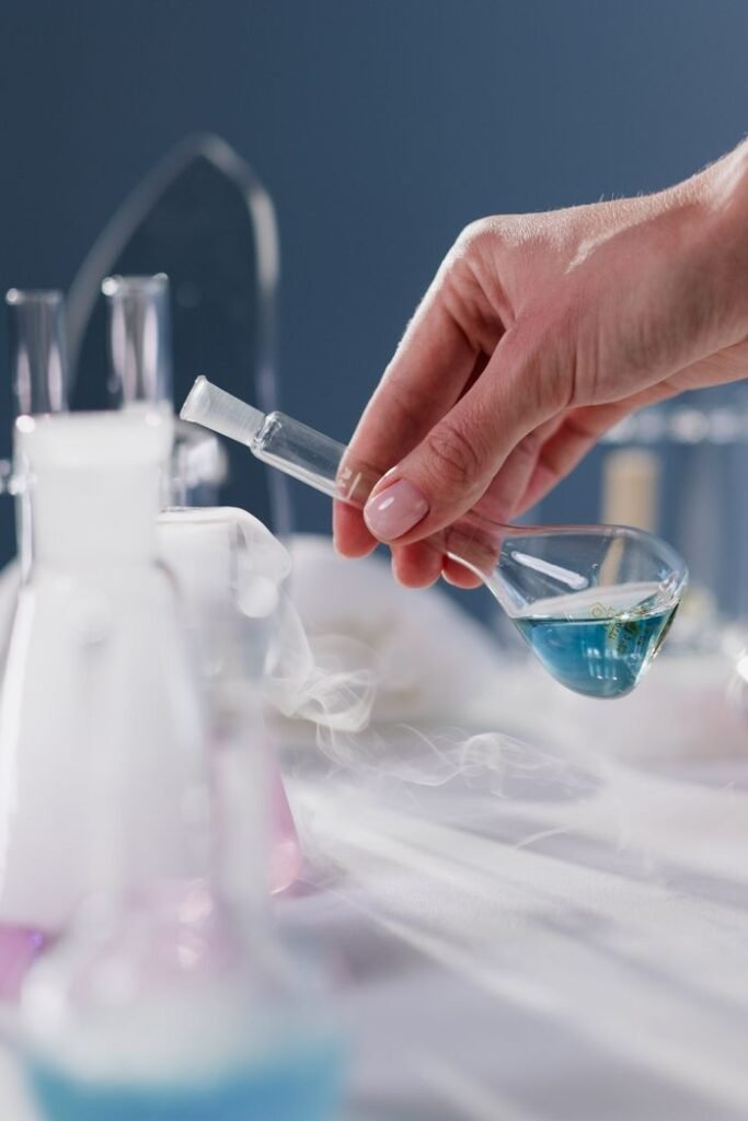 Close-up of a hand holding a flask in a laboratory setting with smoke effect.