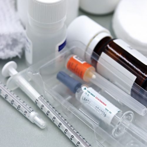 Detailed image of syringes and vaccine vials, illustrating immunization tools.